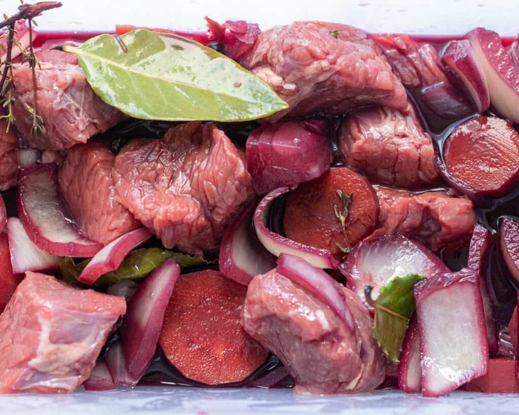 The marinade is poured over the diced beef.