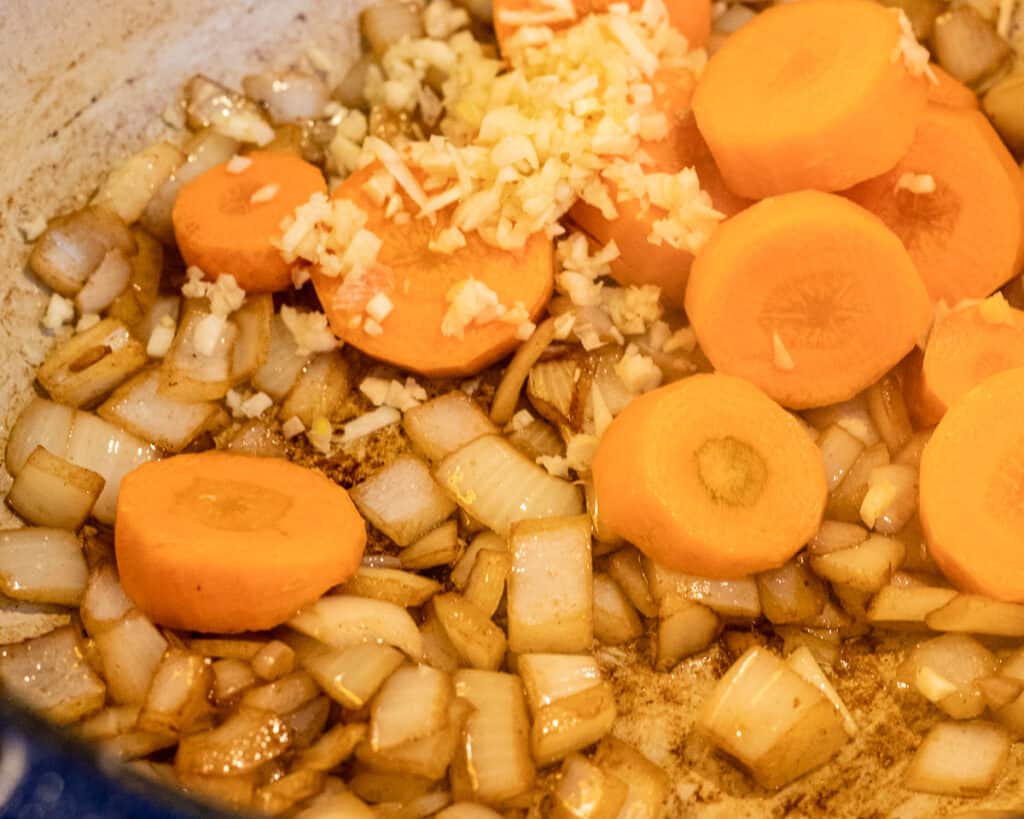 Sautéing the sliced carrots and garlic