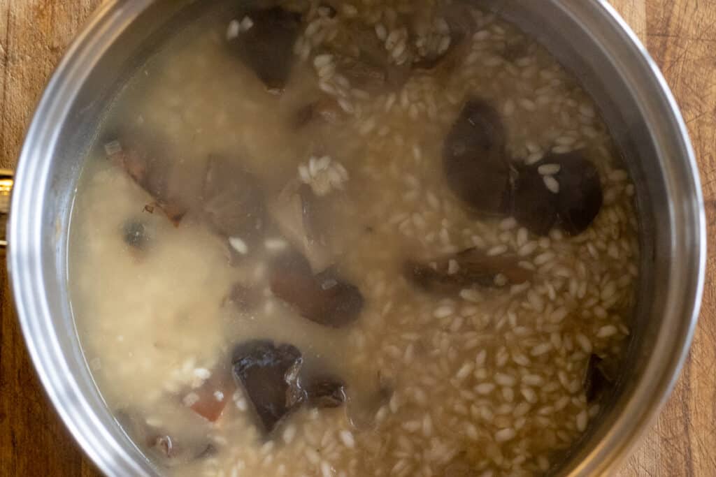 Adding the stock to the rice.