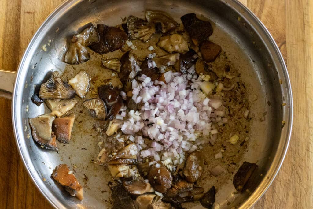 Shallots added to the sautéed mushrooms.