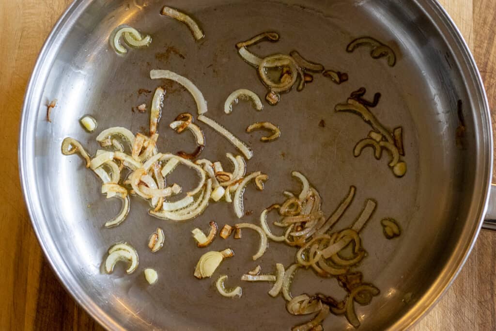 Sautéing the shallots in olive oil.