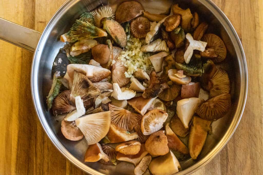 Sautéing the mushrooms in a pan.