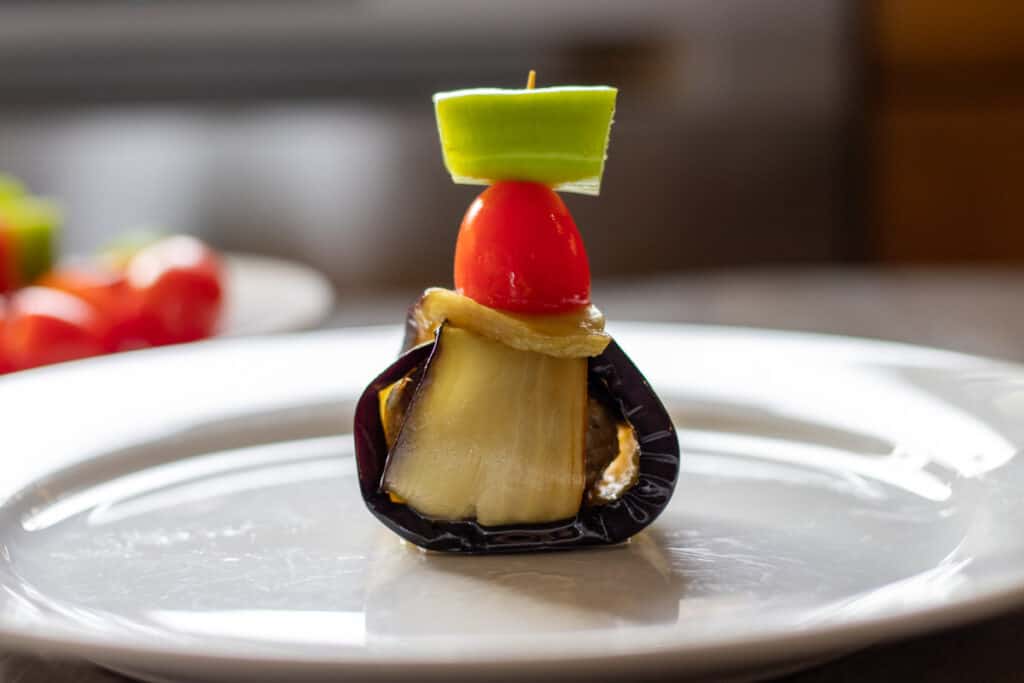 A wrap secured with a toothpick through pepper and tomato.