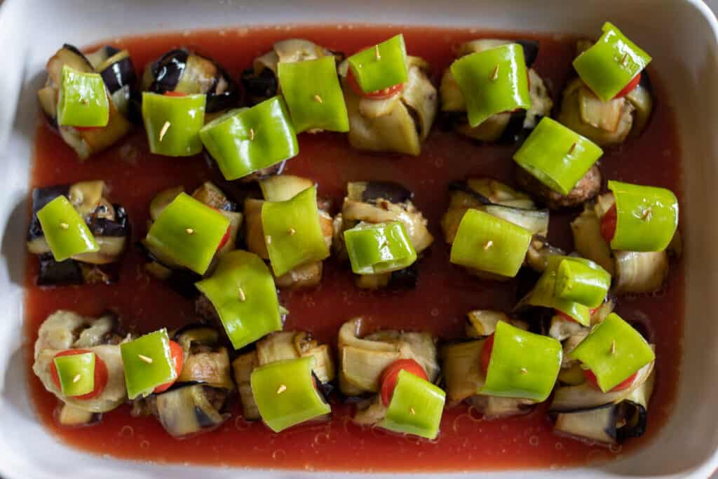 Tomato sauce poured around the wraps in the baking dish.
