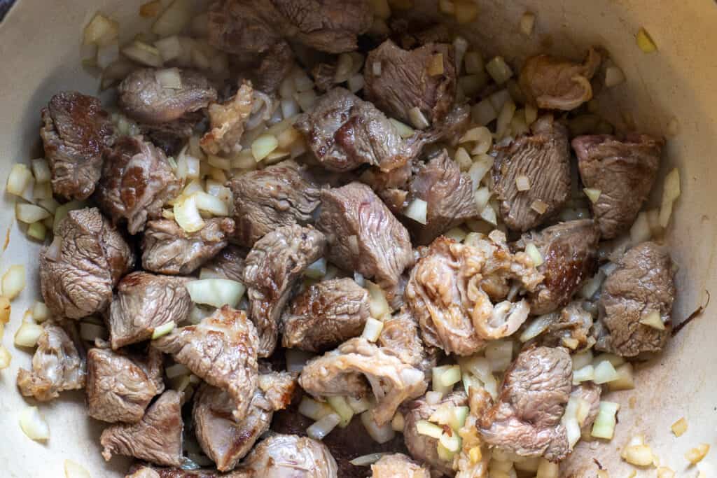 Sautéing the onions with beef.