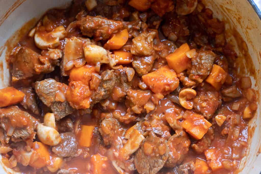 Mushroom stock is added to the pot.