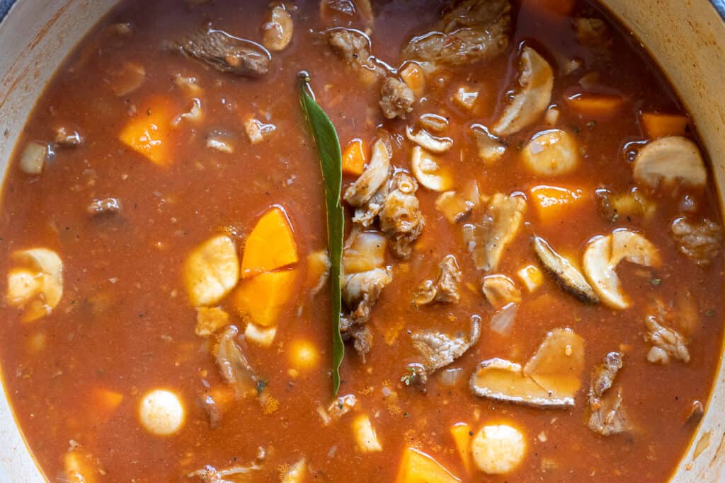 The beef stock is added to the pan.