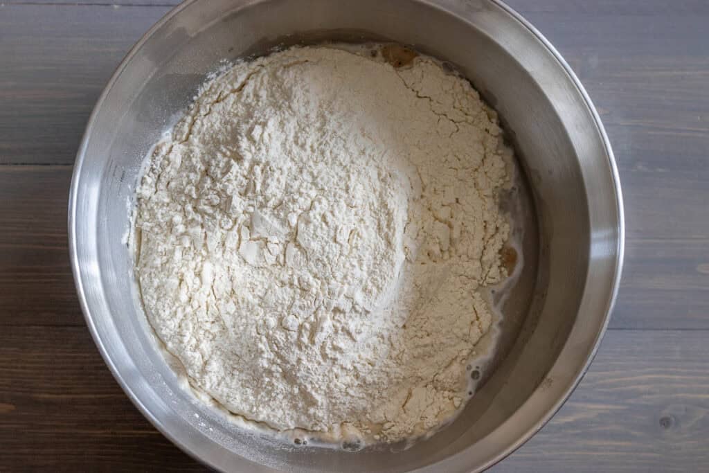 The flour, salt, and yogurt are added to the yeast mixture.
