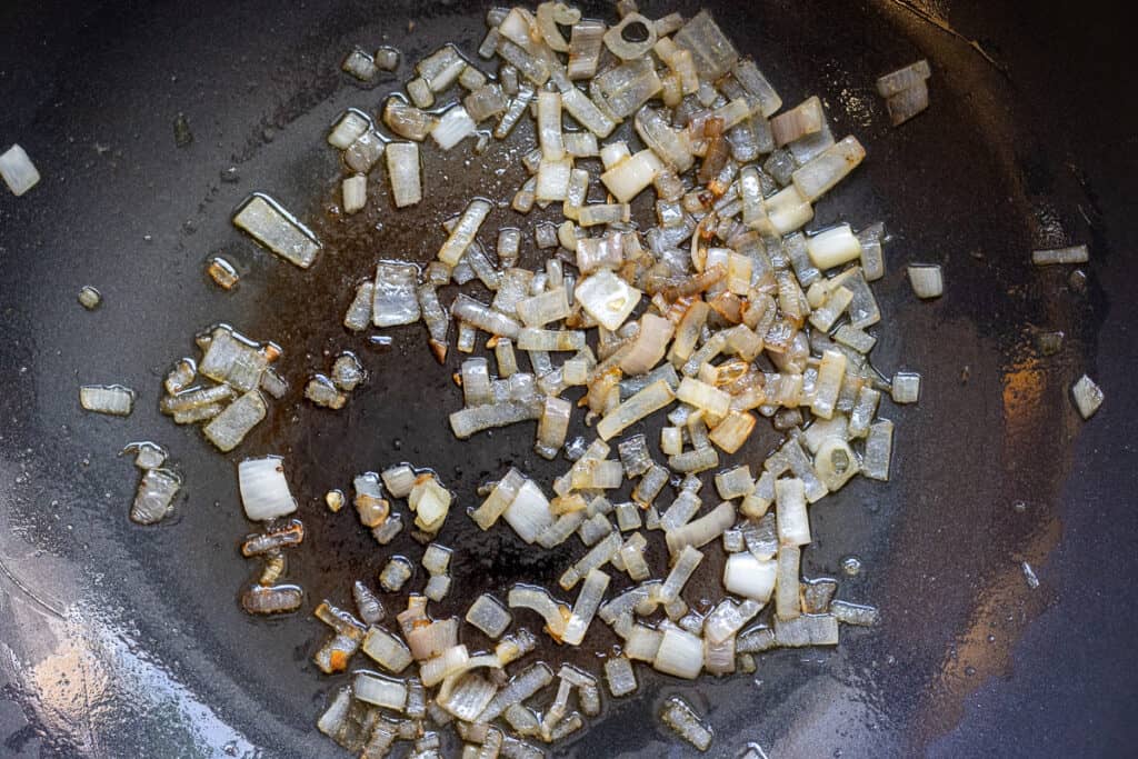 Sautéing the shallots in butter.