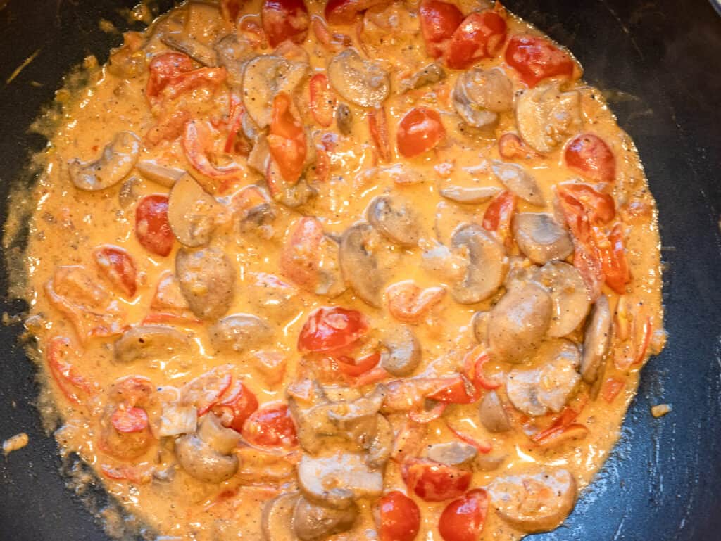Mascarpone and heavy cream stirred into the tomato and mushroom sauce.