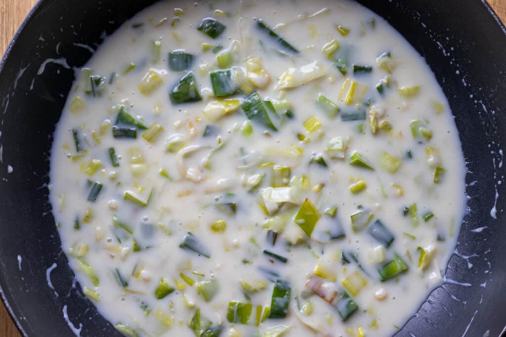 The milk added to the flour and leek mixture.
