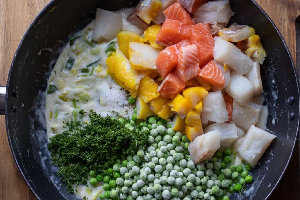 The fish added to the creamy leek sauce.