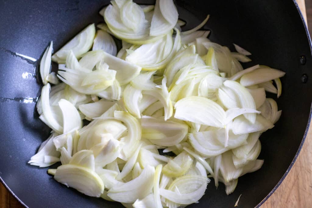 Caramelising the onions in a large pan.