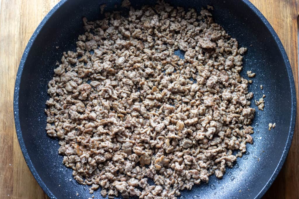Browning the ground lamb a pan.
