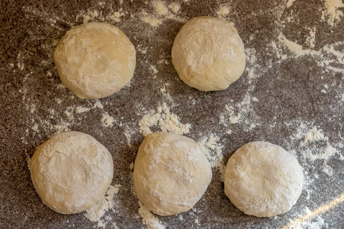 The dough is divided into 5 pieces and shaped into balls.
