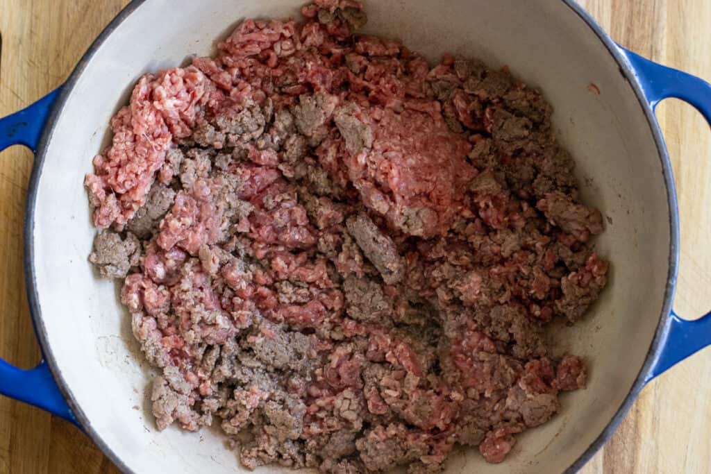 Browning the beef in a Dutch oven.