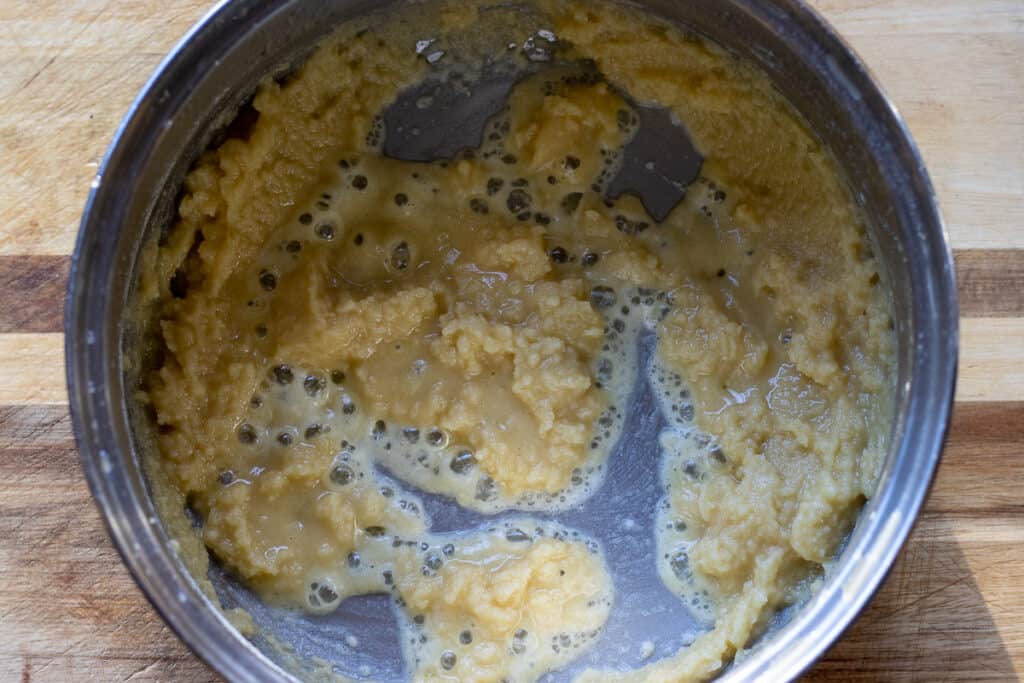 Flour and melted butter are mixed in a pan.