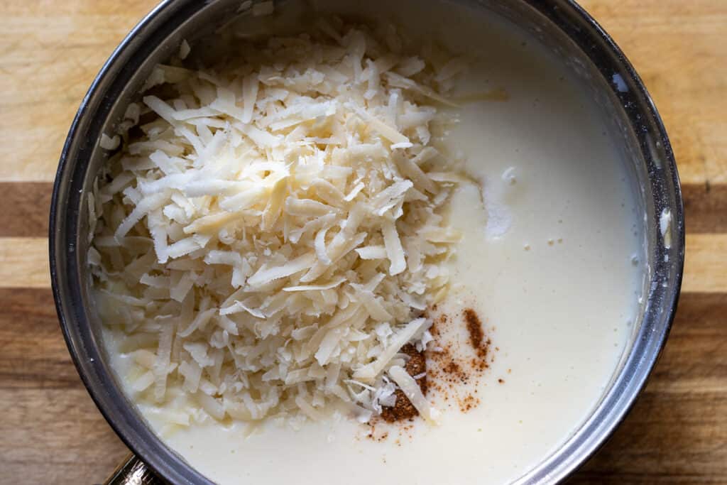 Salt, nutmeg and cheese are added to the béchamel.