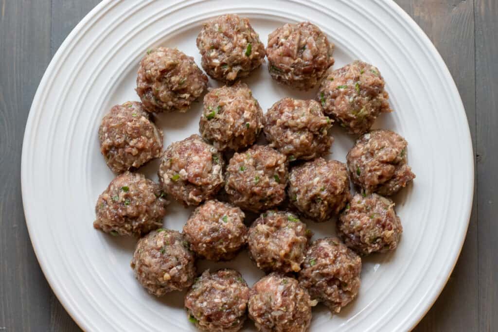 Meatball mixture is shaped into small balls.