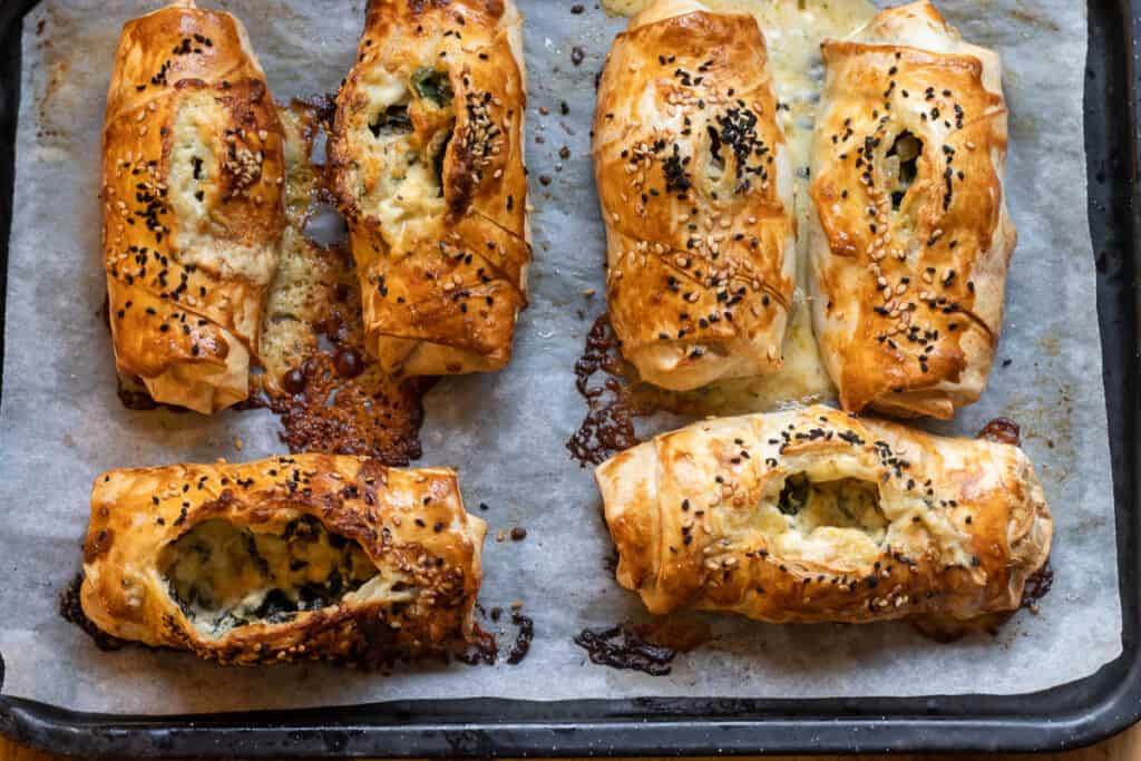 6 pieces of baked borek on a baking sheet.