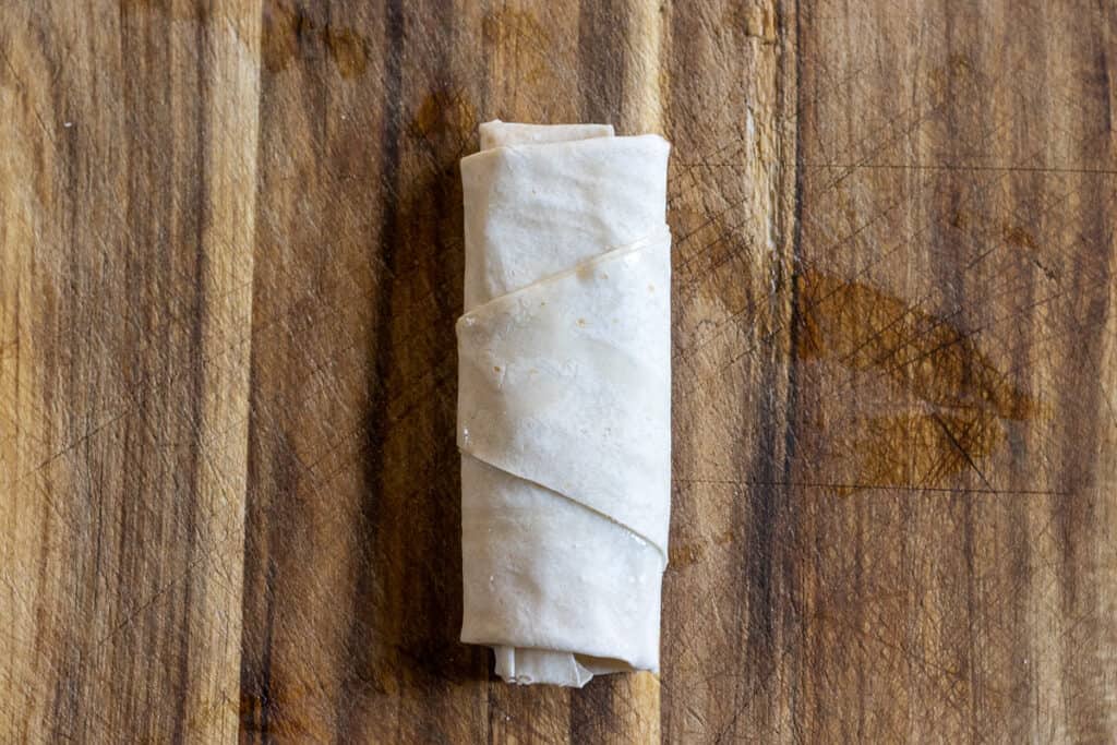 The triangle is rolled into a cigar shape.