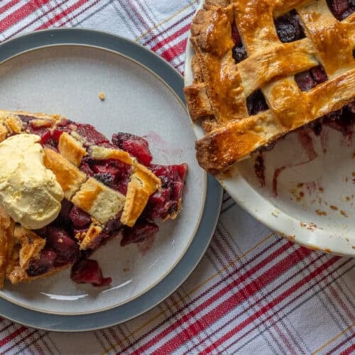 a slice of apple and blackberry pie served with ice cream