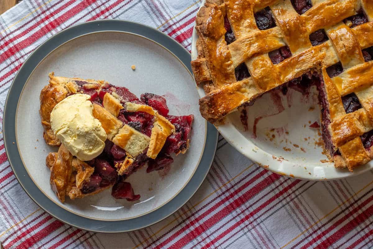 a slice of apple and blackberry pie served with ice cream
