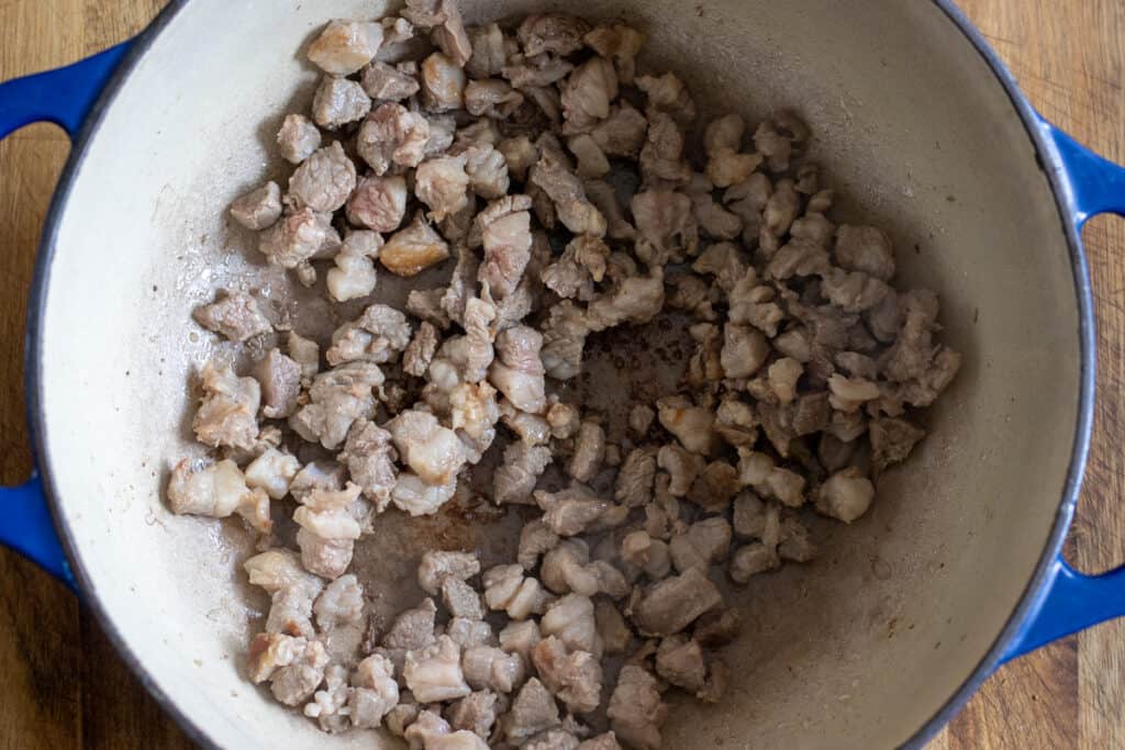 Lamb browning in a Dutch oven.