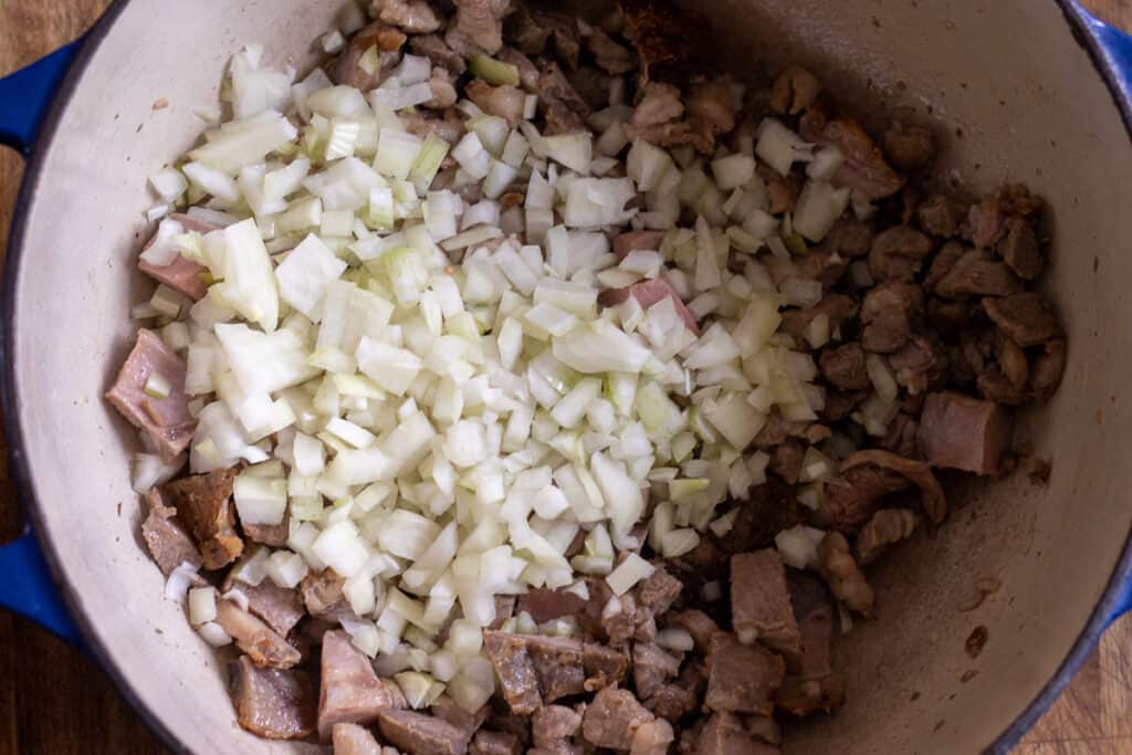 Onions and garlic sauteing with the browned lamb.