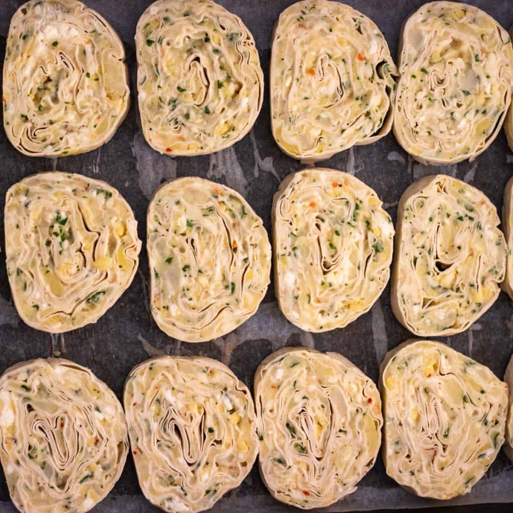 Slices of potato borek slices layered on a baking tray