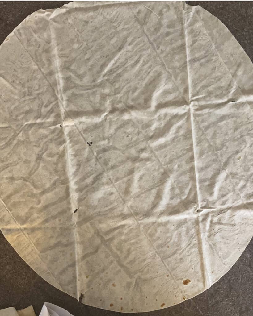 A sheet of yufka laid on the worktop.