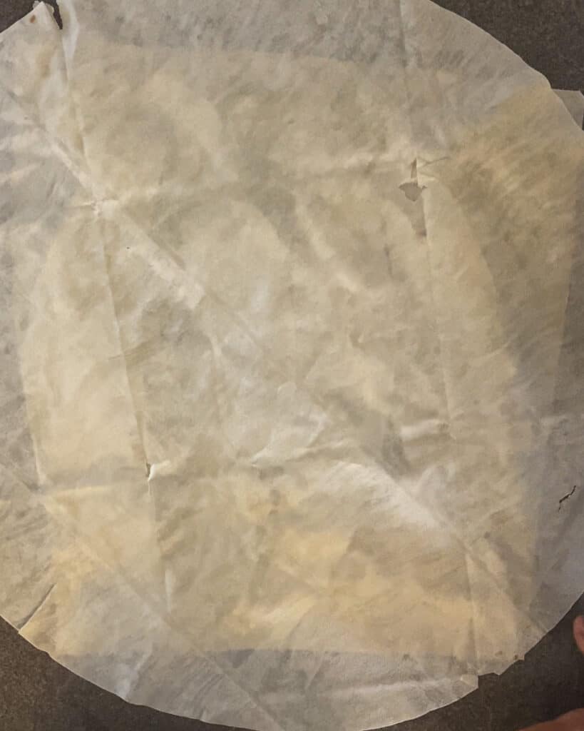 A second yufka sheet laid over the potato filling.