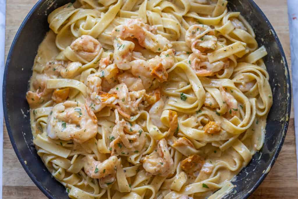 Close-up of fettuccine coated in the creamy sauce with shrimp.