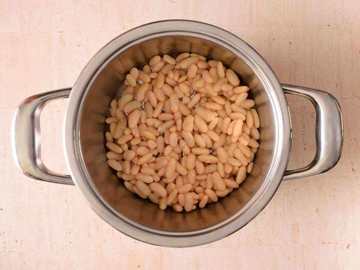 White beans are cooked and drained.