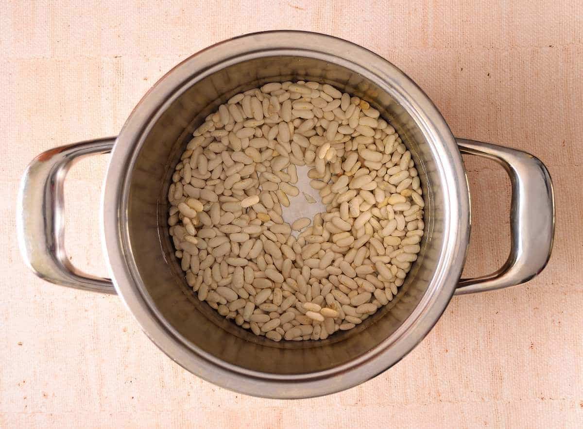Soaking the white beans in a pot.