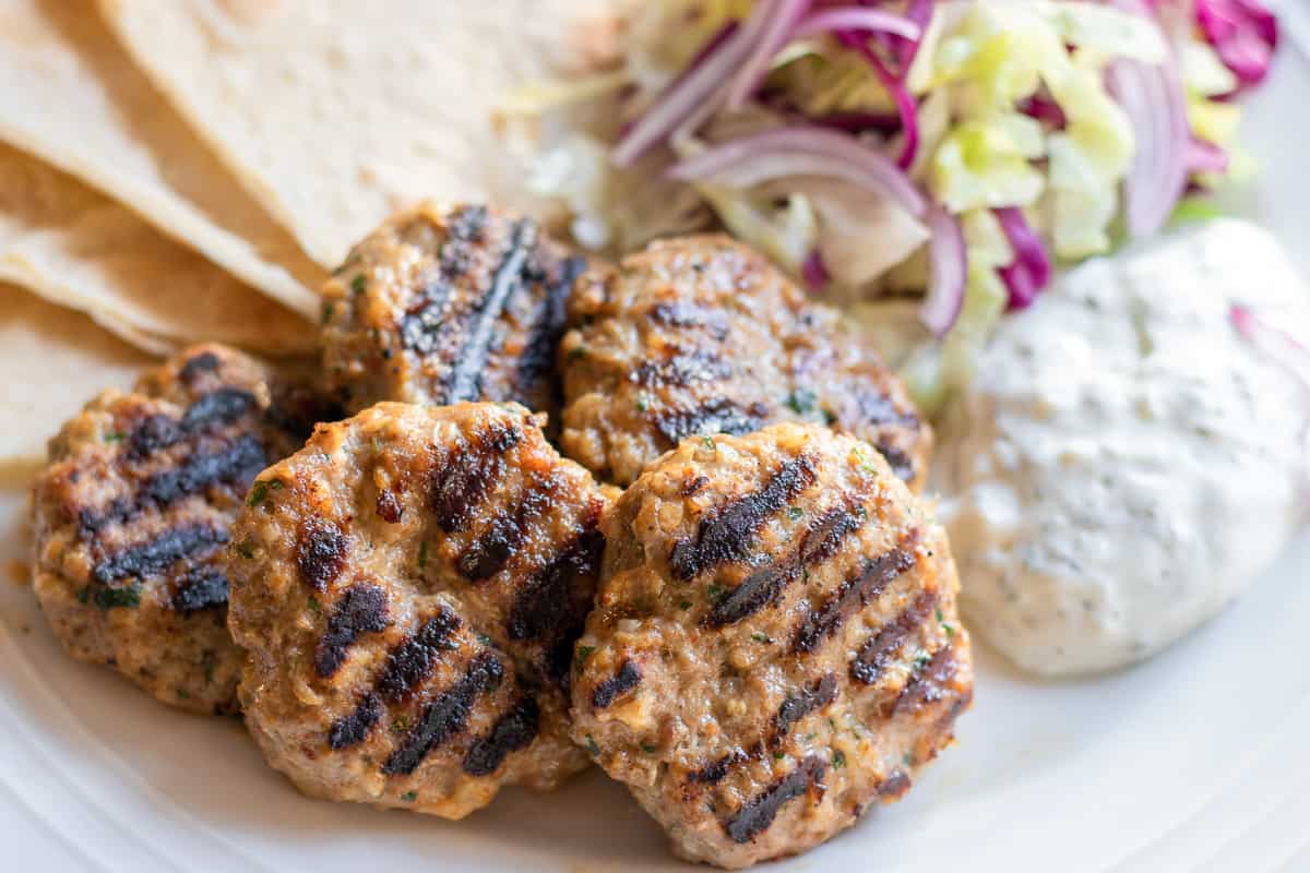 grilled lamb kofte served with salad and pita bread
