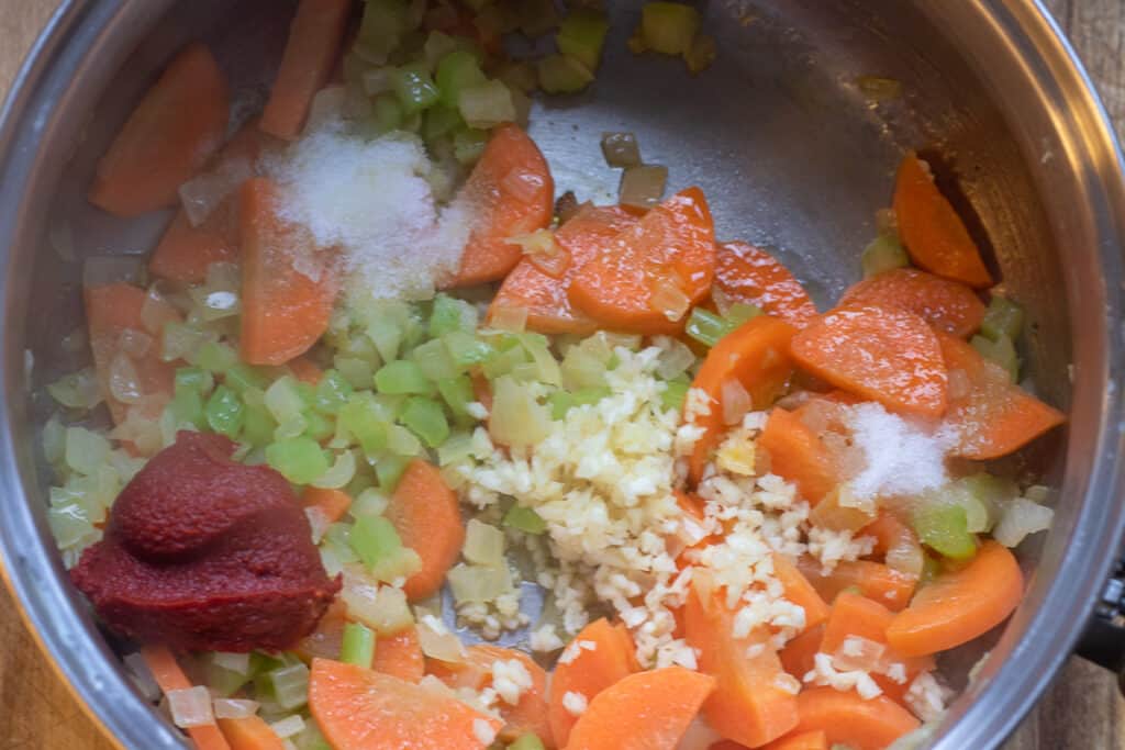 add garlic, tomato paste, salt, sugar and sauté for a few minutes
