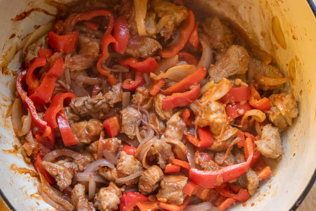 Red wine added to the sautéed lamb and vegetables.