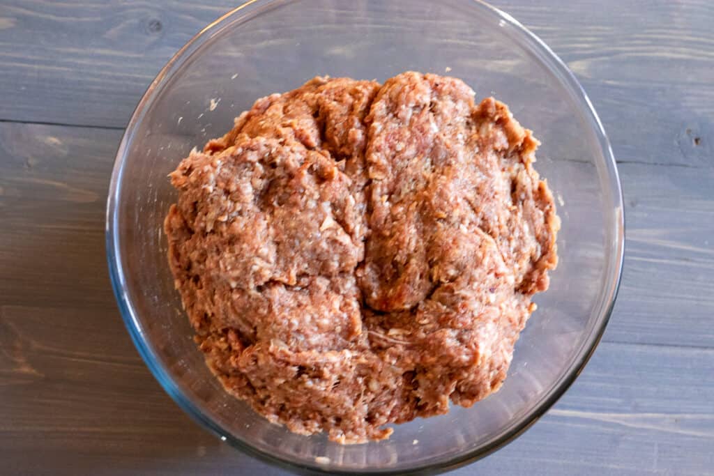 Seasoned ground lamb mixture for Beyti Kebab in a large mixing bowl.