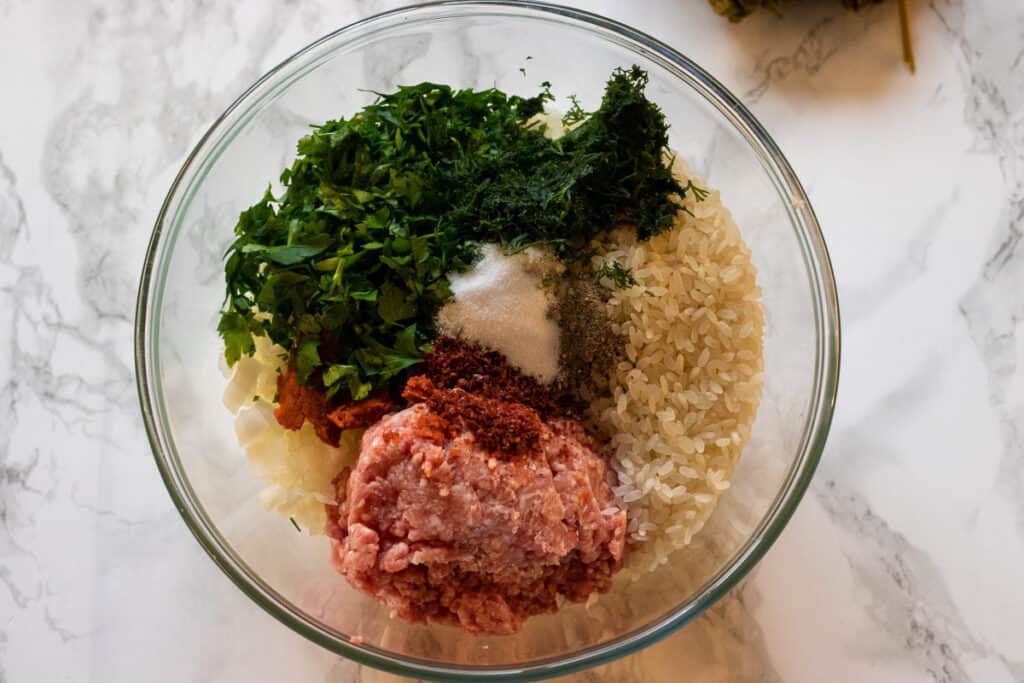 The ingredients for dolma filling are placed in a bowl.