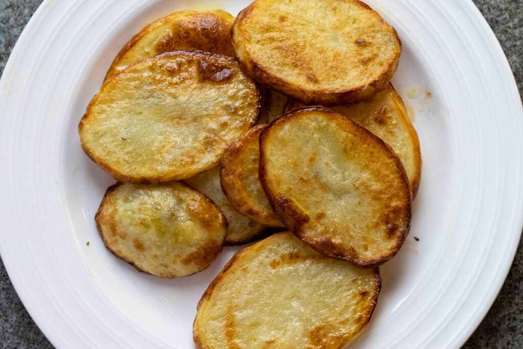 Fried potato slices on a plate.