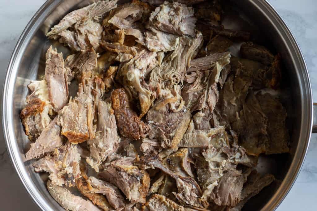 The meat is layered on the bottom of the pan.