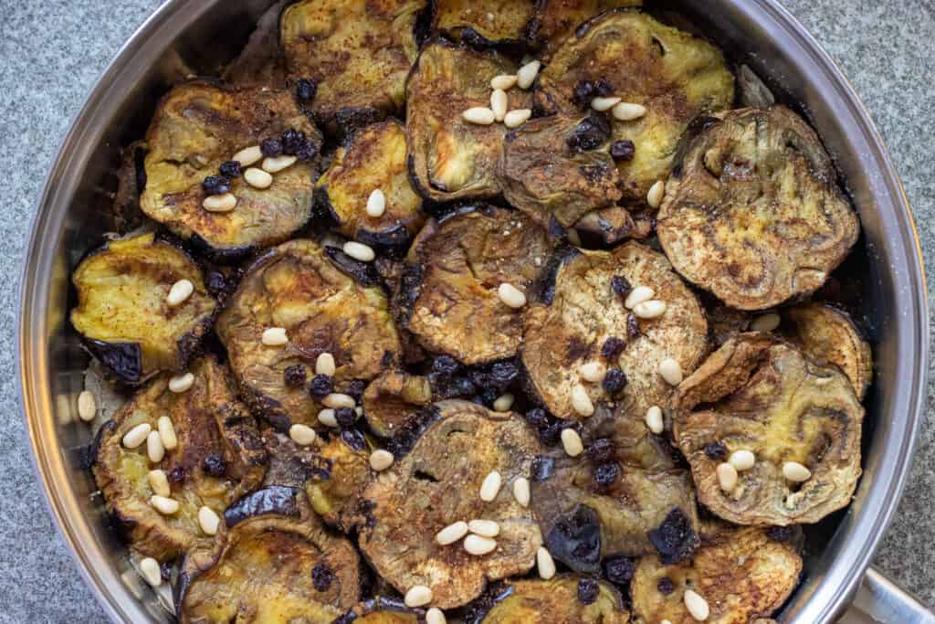 The eggplant slices are layered on top of the meat.