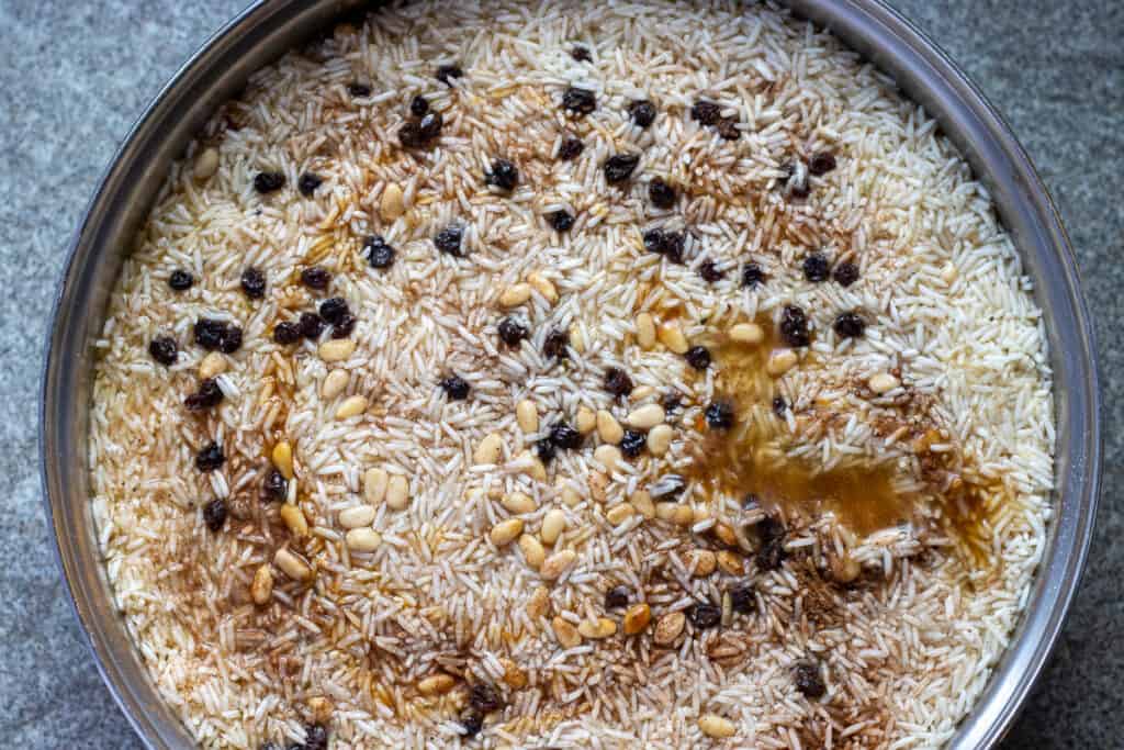 The rice is layered on top of the potatoes.