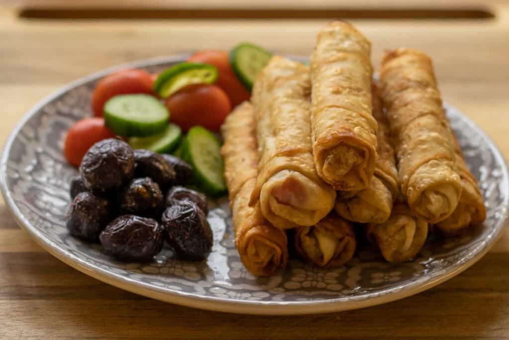 pacing boregi served with olives, tomatoes and cucumbers