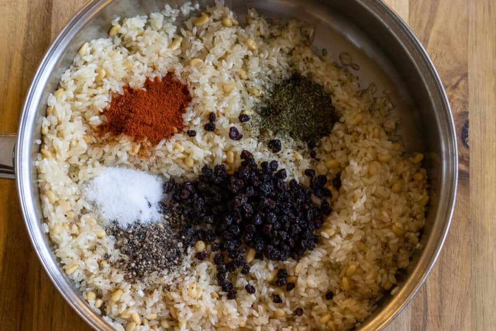 The currants and spices are added to the rice and pine nuts.