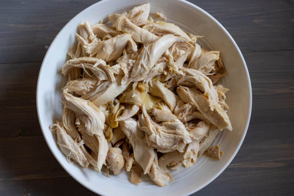 The chicken is shredded before it is added to the rice.