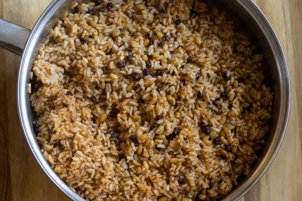 The shredded chicken is mixed with the rice.