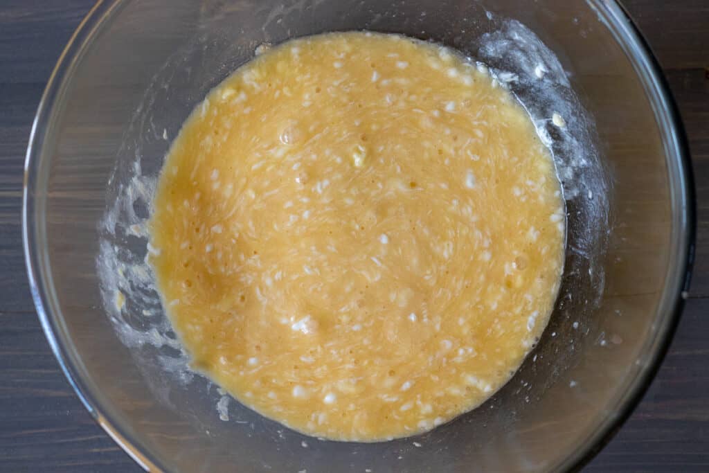 The eggs, yogurt, oil, and butter are whisked in a bowl.