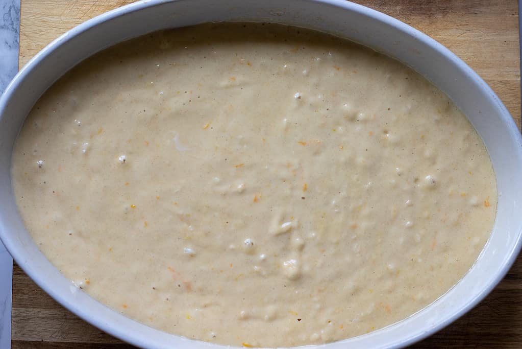 Revani cake mixture is poured into a baking dish.